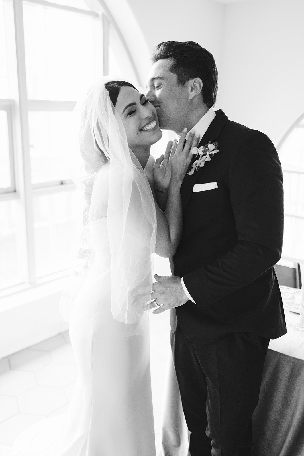 groom kissing bride on the cheek at San Clemente Wedding Venue