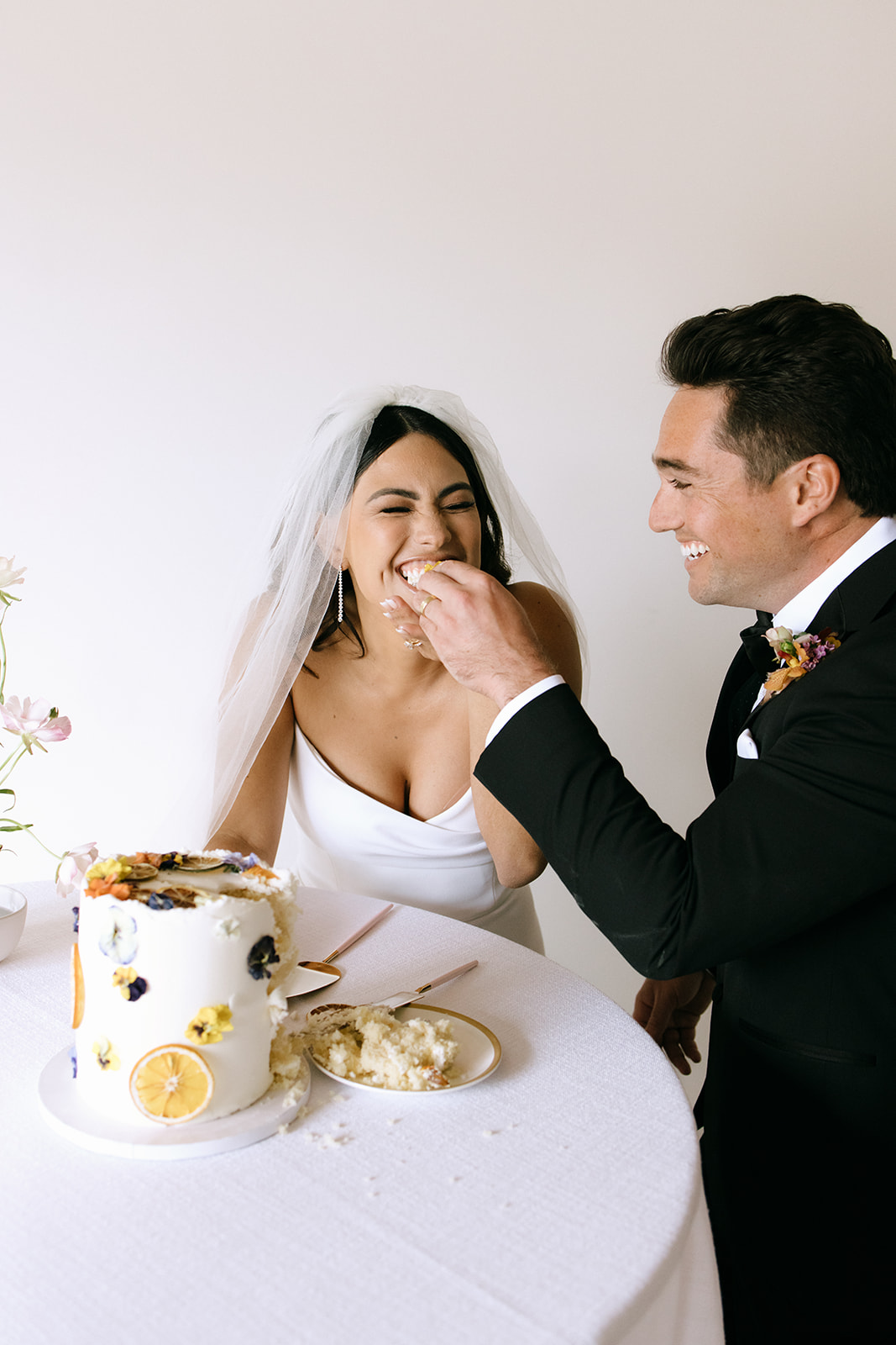 bride and groom eating their wedding cake at San Clemente Wedding Venue