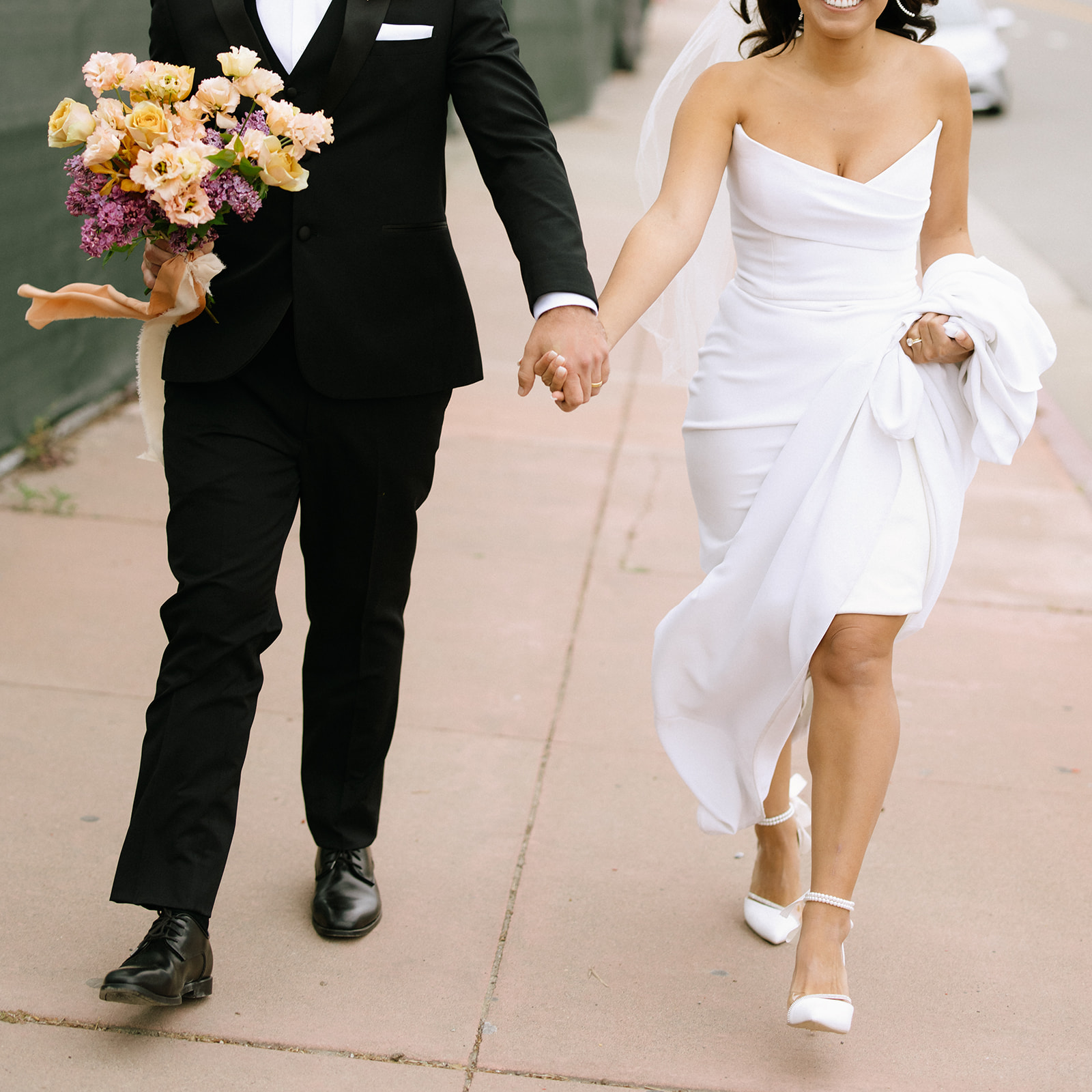 bride and groom walking down the street to the beach 