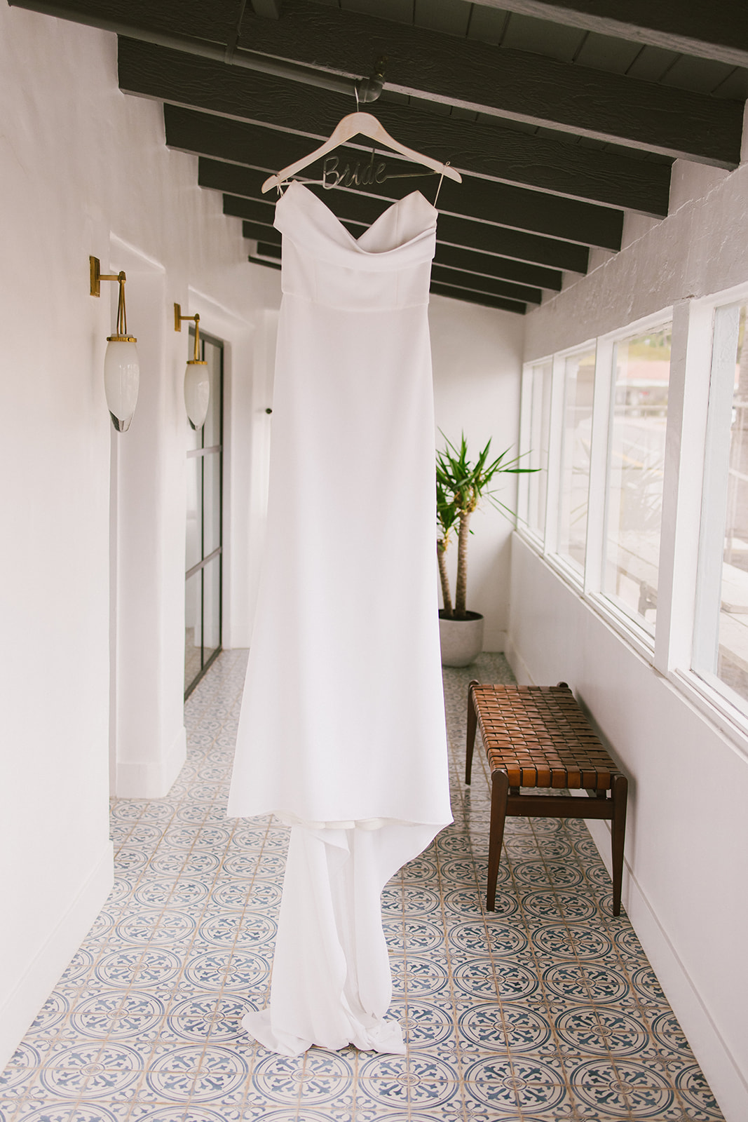 bride's dress hanging in the hall of San Clemente Wedding Venue