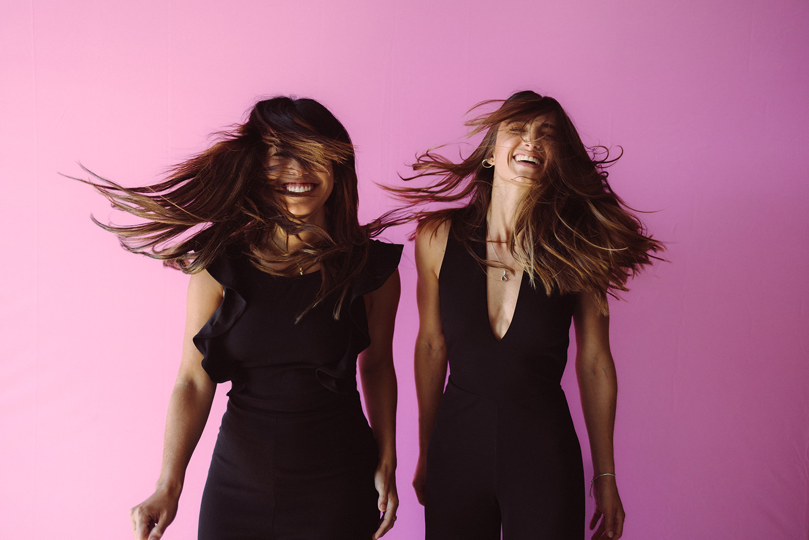 Small Business Branding Photography of two girls smiling with a pink background 