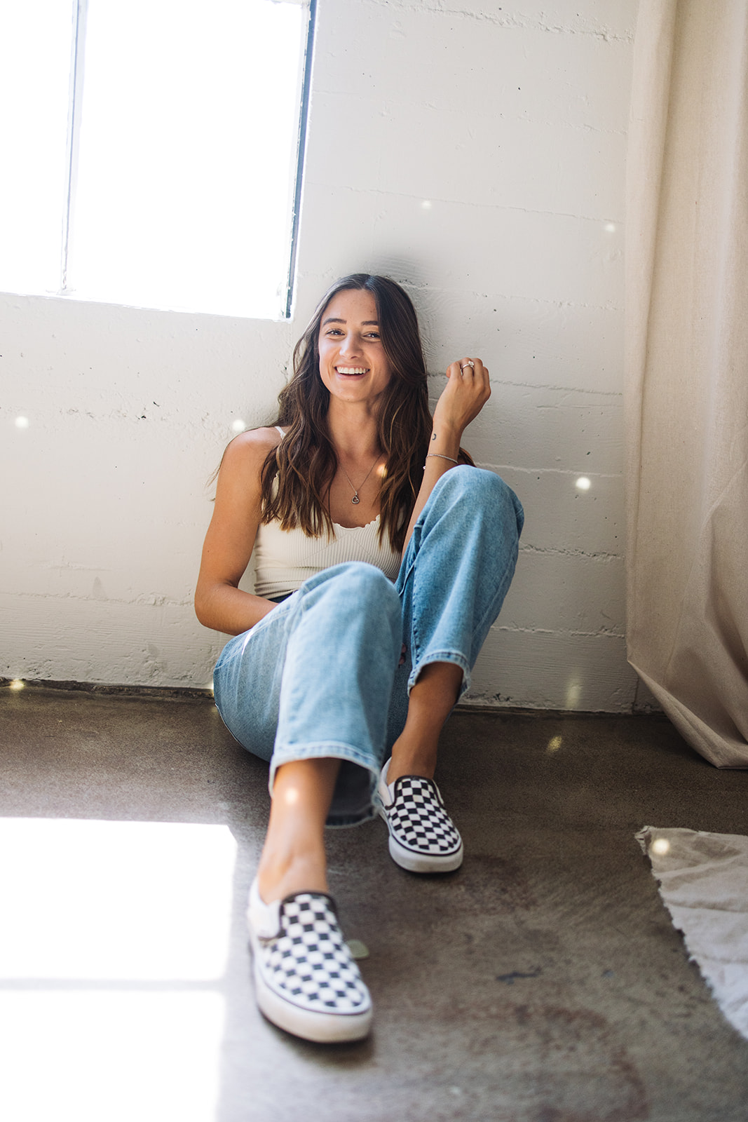 small business branding photo of a woman sitting on the ground against a wall 