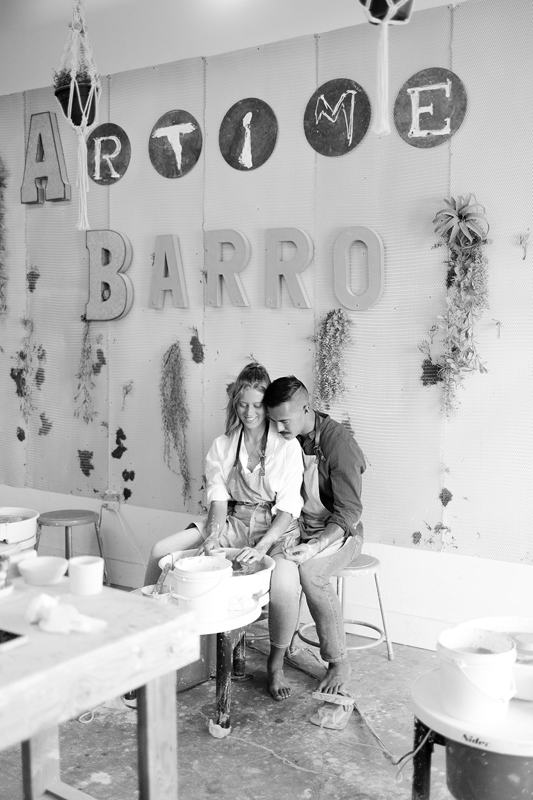 black and white of a couples making pottery 