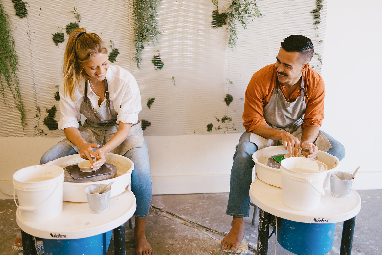 a couple making pottery together at a studio in California 