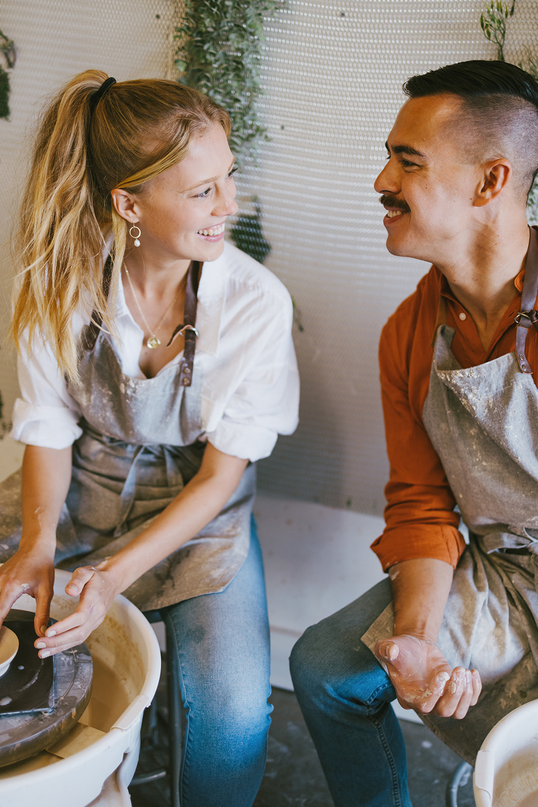 a couple smiling at each other during a date night photoshoot 