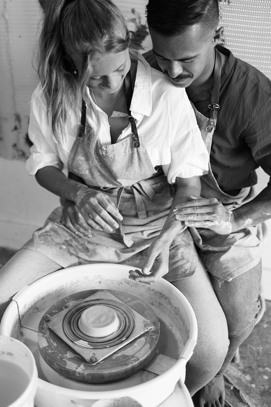 a couple doing pottery together during a date night photoshoot 