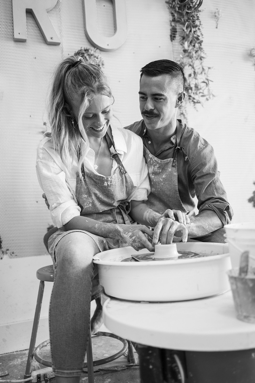 a couple making pottery together at a studio