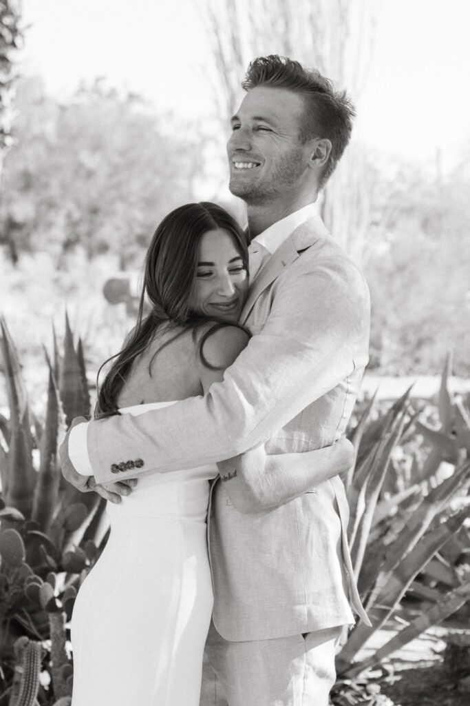 bride and groom hugging 