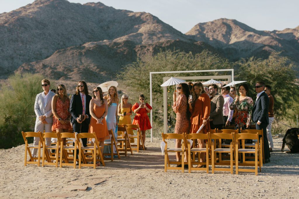 Palm Springs wedding guests standing before the bride walks down the aisle 