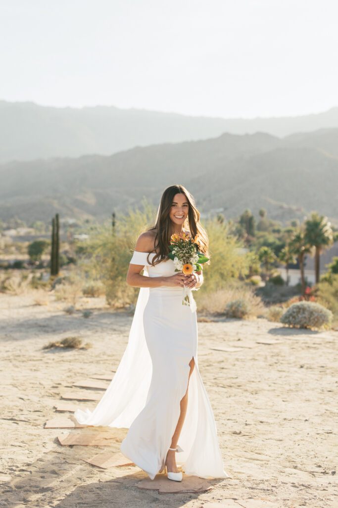 Palm Springs wedding bride walking down the aisle smiling 