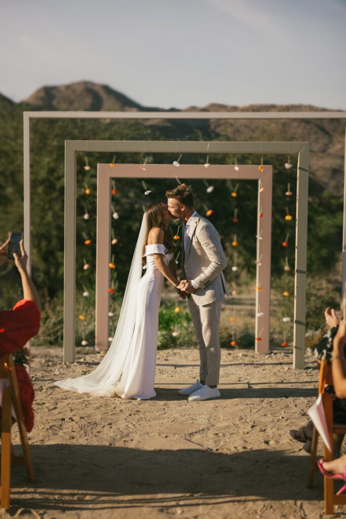 bride and groom kissing at the altar 