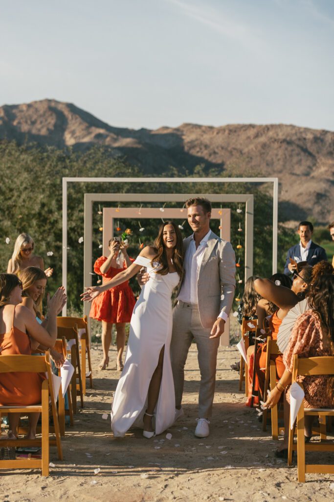 bride and groom walking dow the aisle after the Palm Springs wedding ceremony 