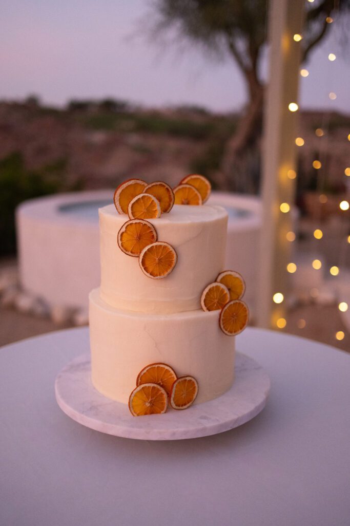 white wedding cake with oranges on it