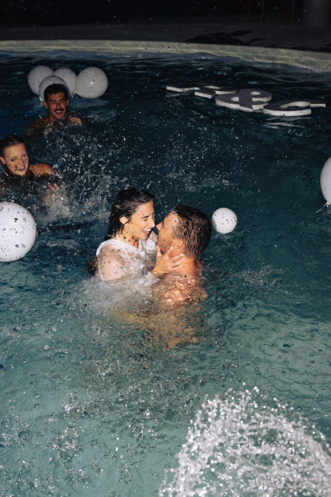 bride and groom after they jumped into the pool