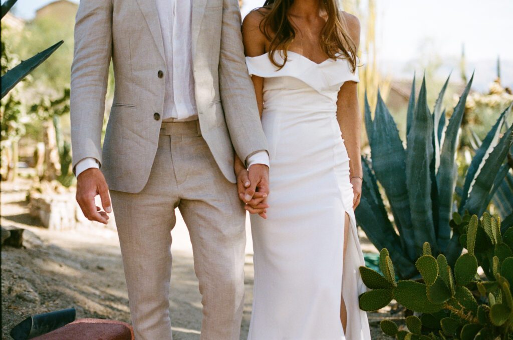 bride and groom walking hand in hand 