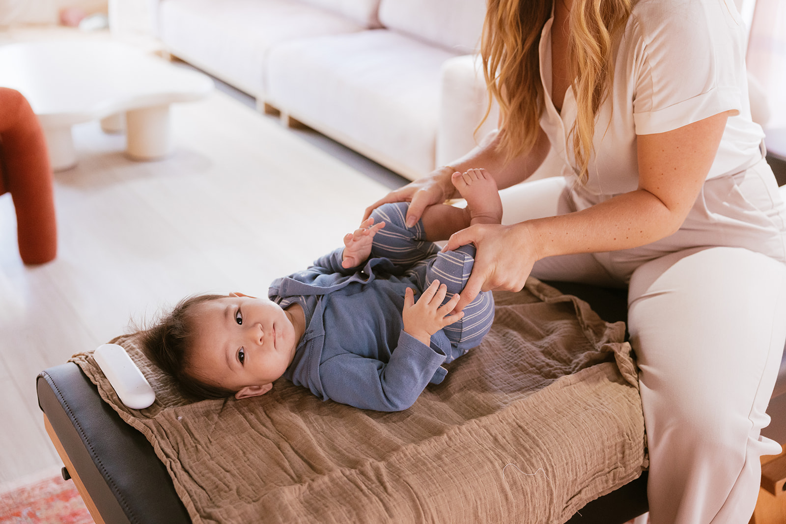 a baby getting an adjustment at the chiropractor 