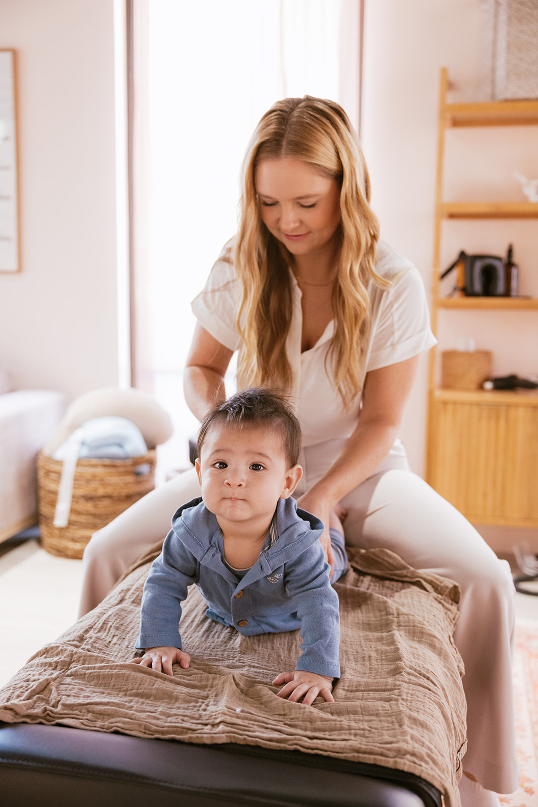 a Chiropractor working on a child during branding photos 