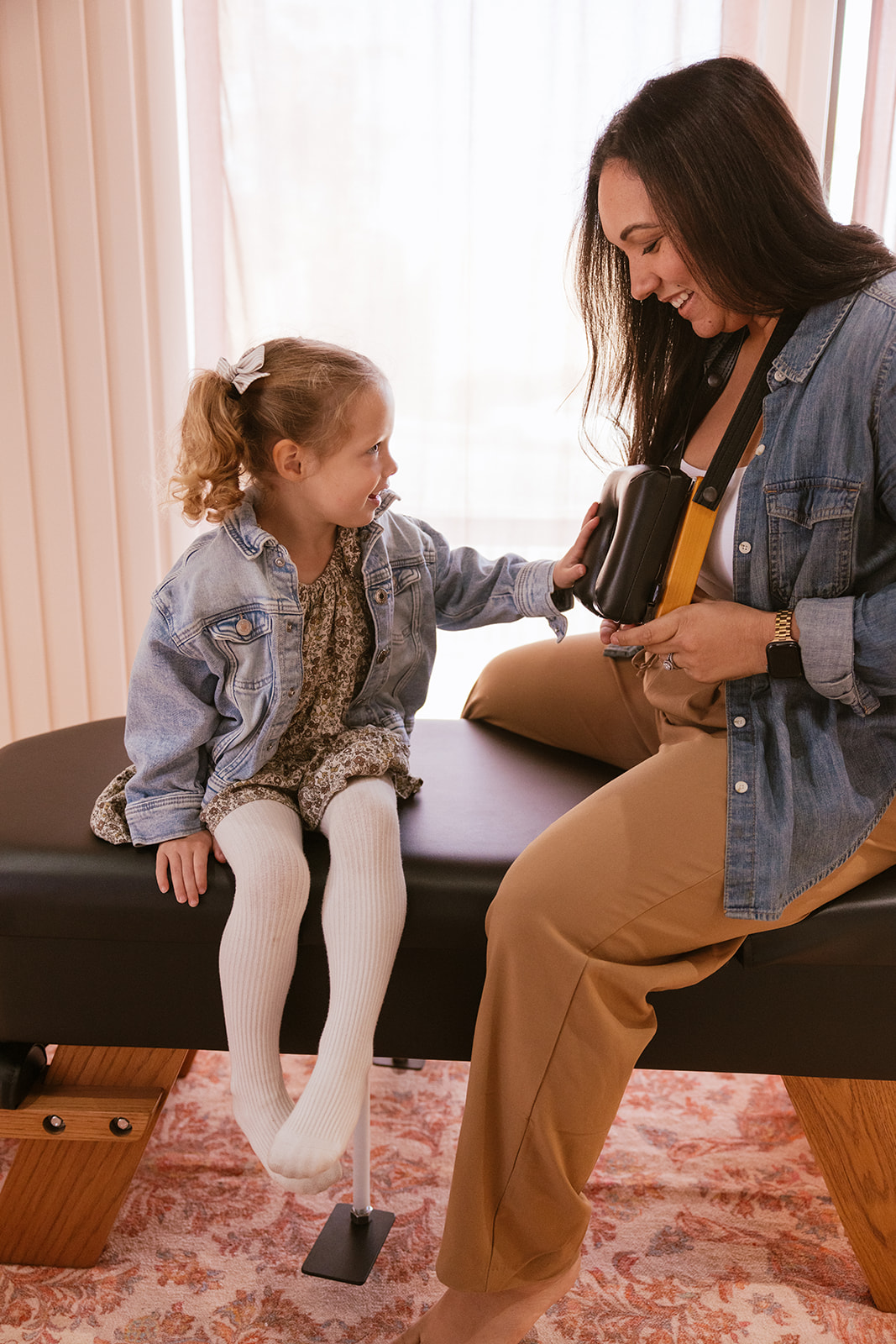 lifestyle branding photography for a Chiropractor as she talks with a child in office