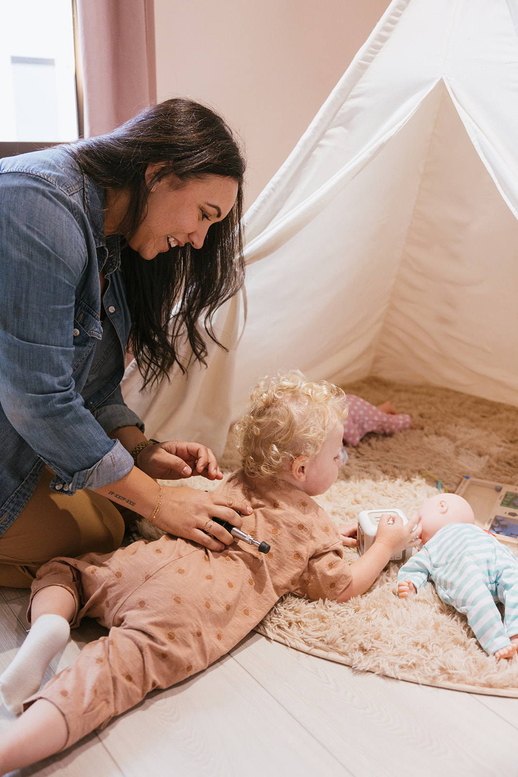 lifestyle branding photography for a Chiropractor as she works on a child as he is playing