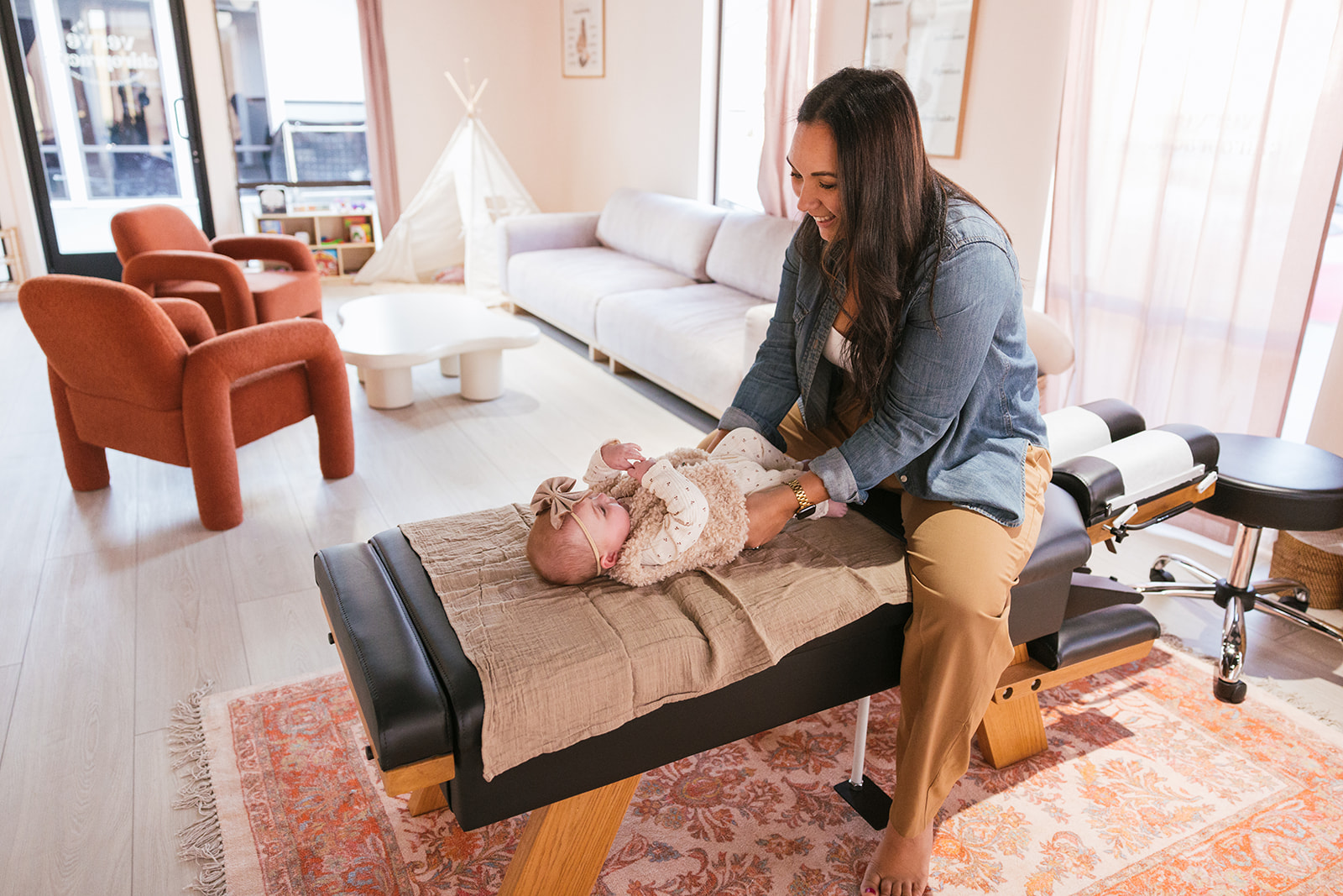 client interaction as the doctor works on a baby 