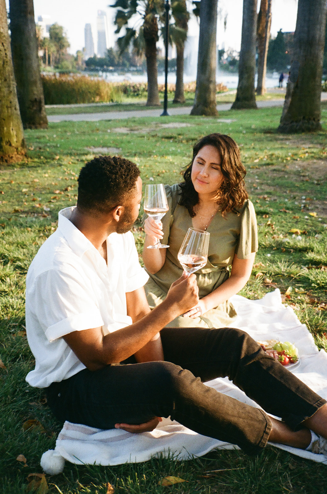 a couple having a picnic in the park shot on 35mm film