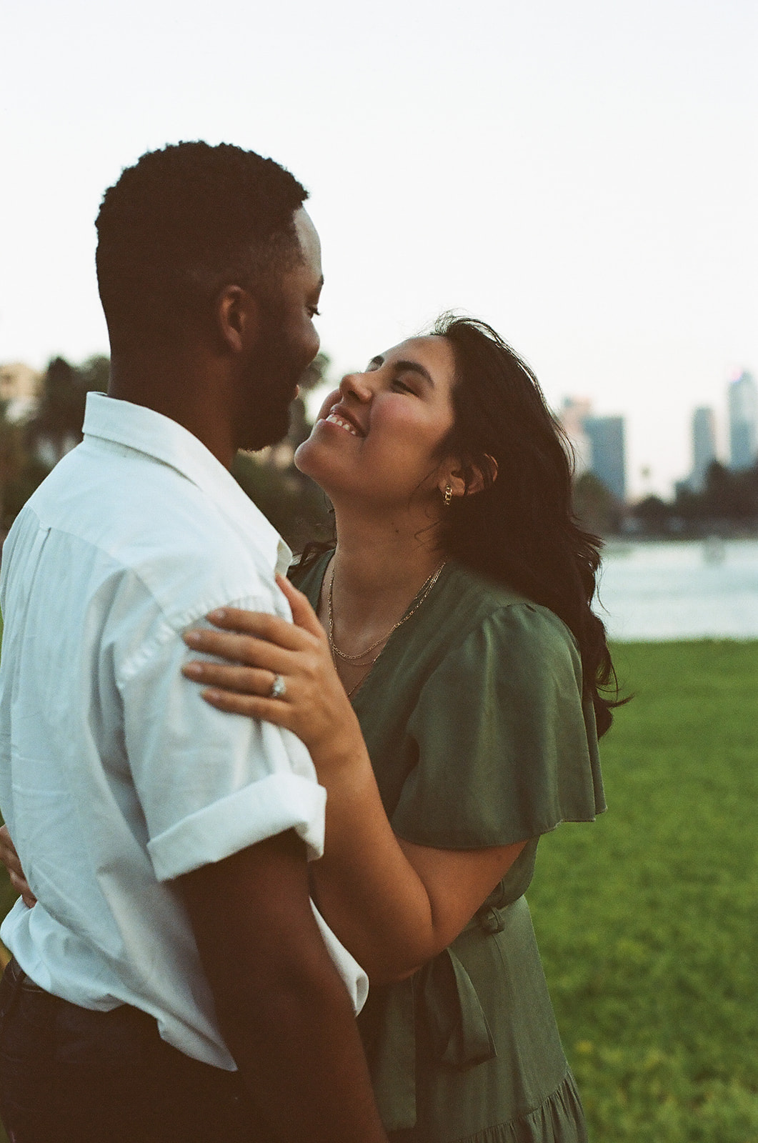 a couple leaning in and smiling together 