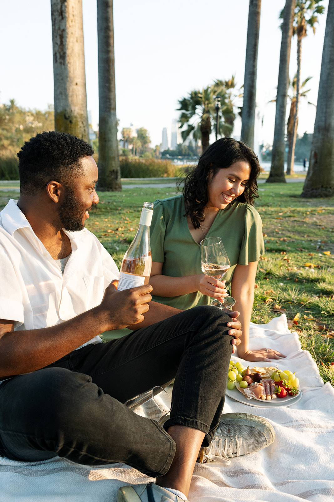 a couple having a wine picnic during their fun couples photoshoot in California 