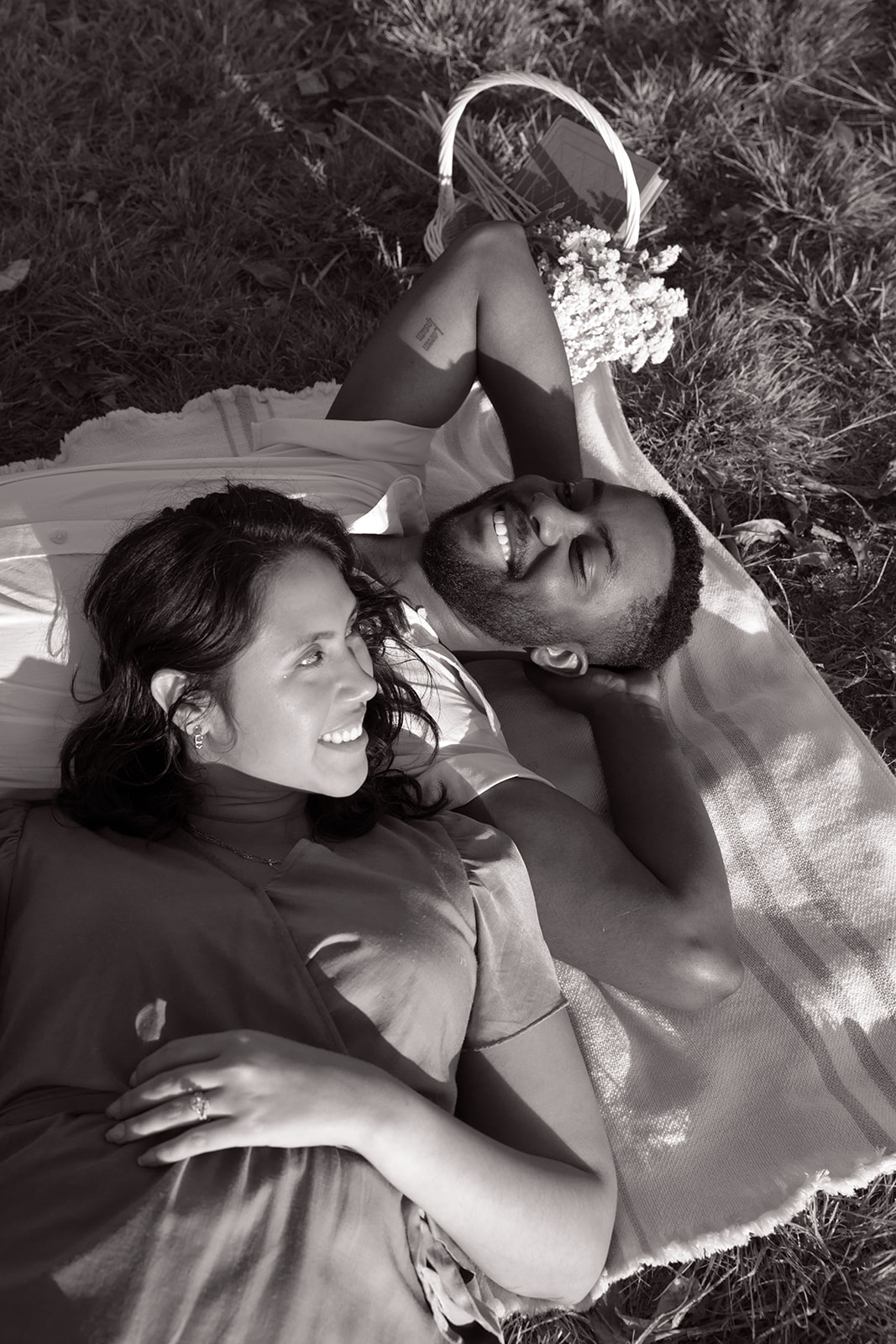 a couple laying on a blanket during their picnic photoshoot in LA