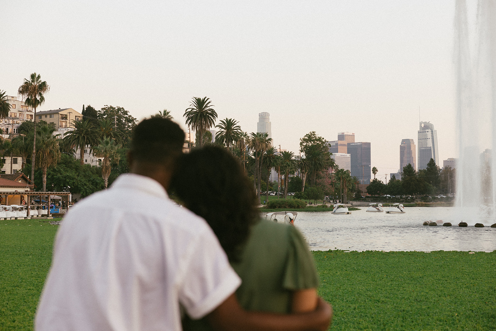a couple blurred as the park in the background is in focus 