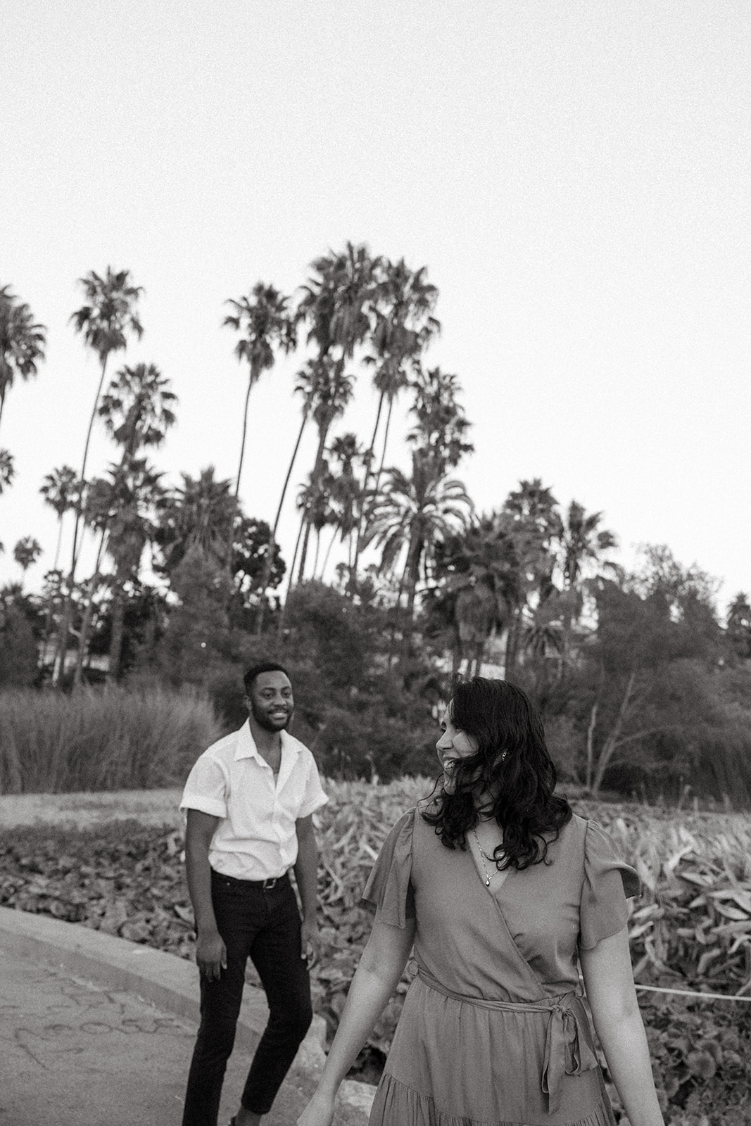 a couple walking through a park together in southern California