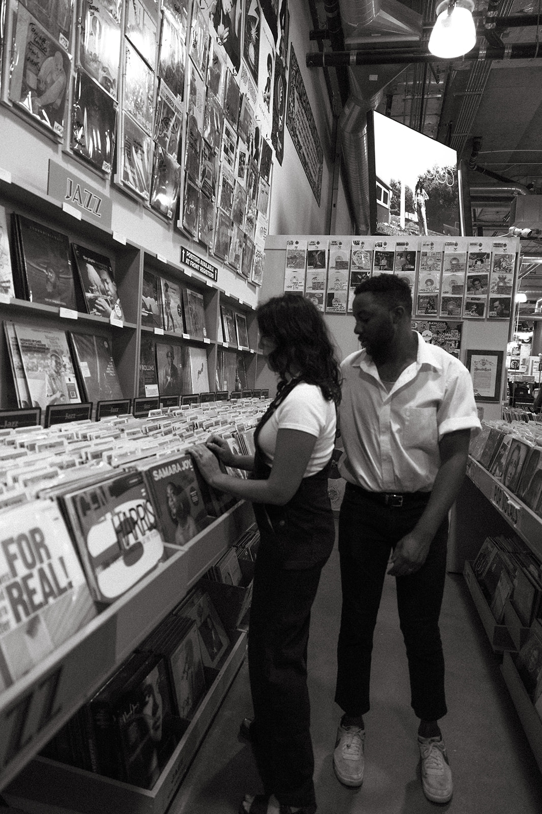 candid moments as a couple looks at records together 