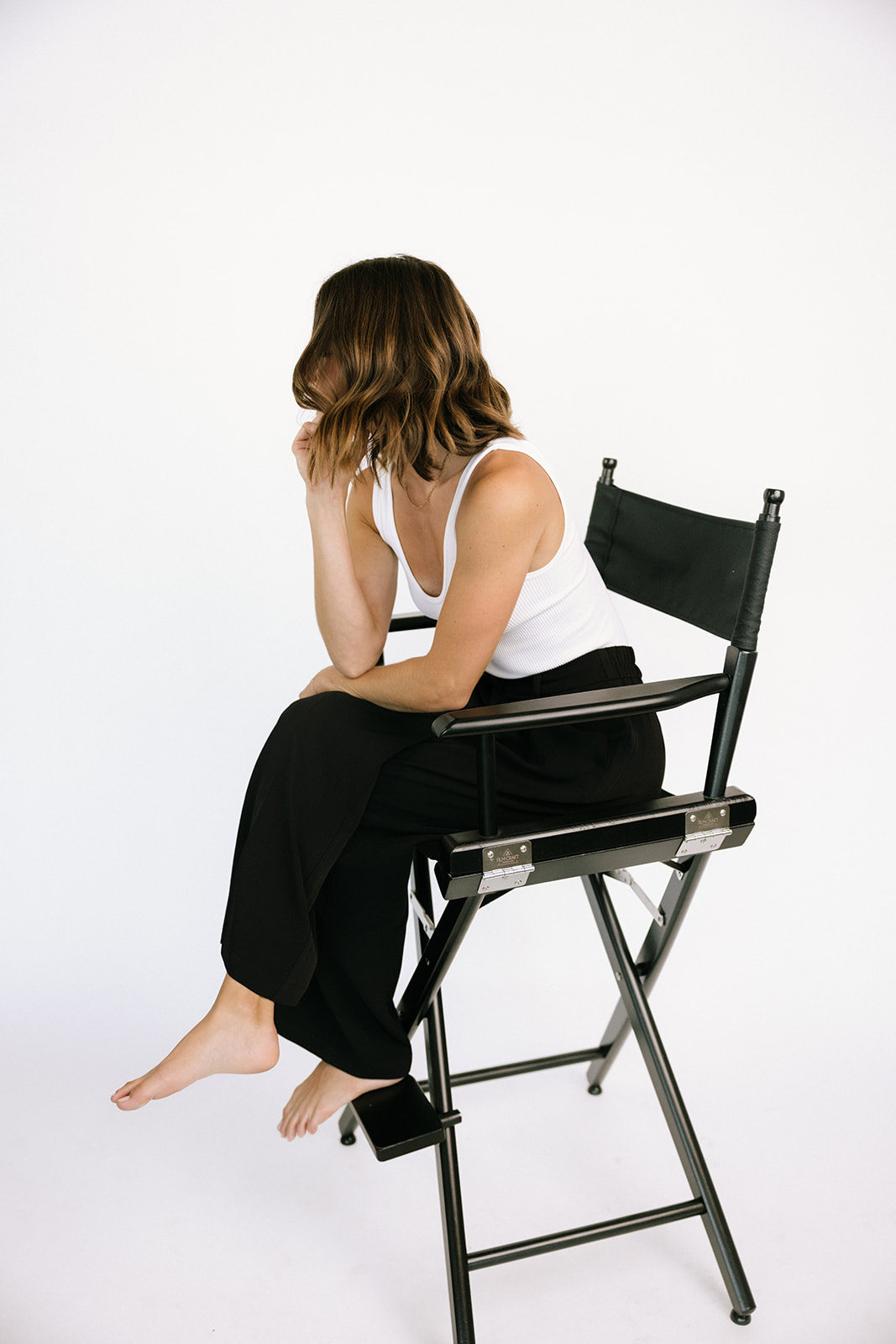 a woman in a chair in studio for a brand photoshoot