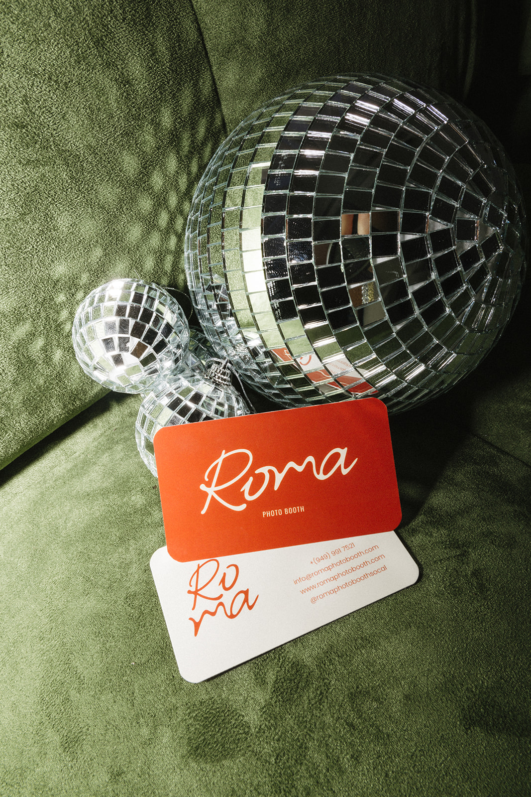 disco balls and business cards on a green couch 