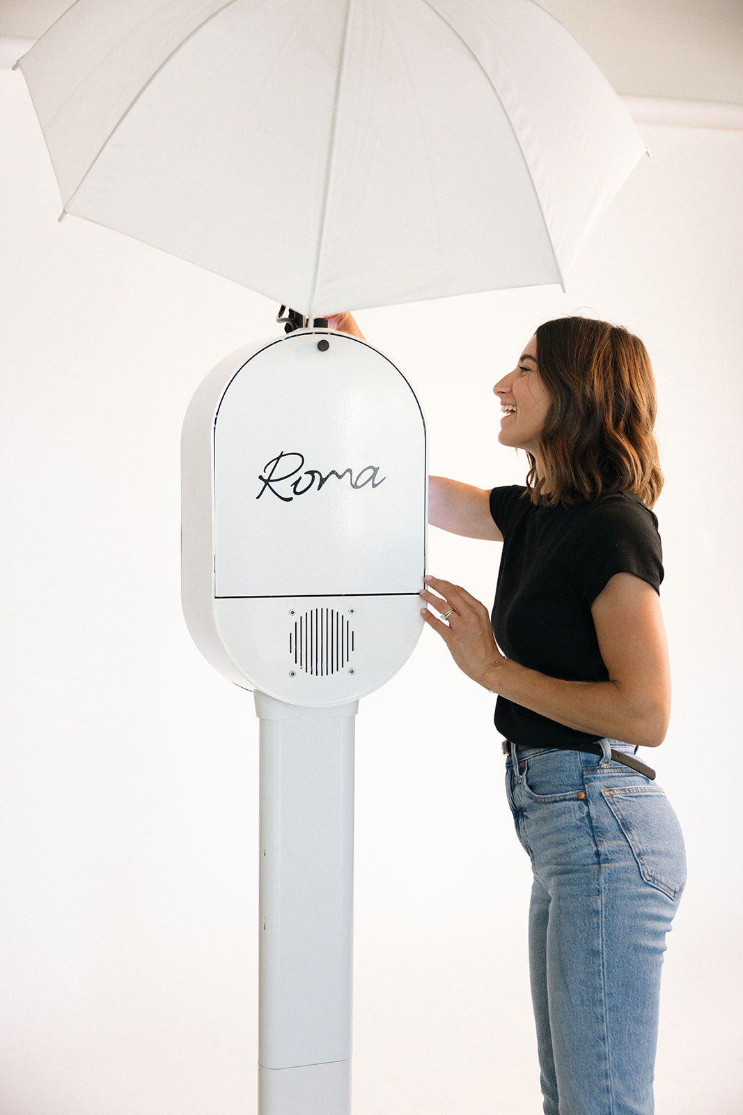 a woman setting up her photo booth in studio for a branding photography session