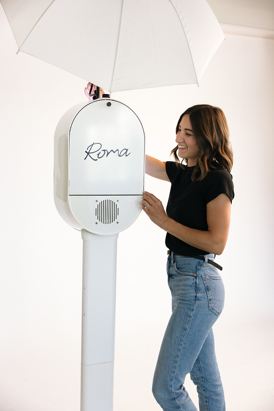 a woman setting up her photo booth during a branding photography session in Costa Mesa