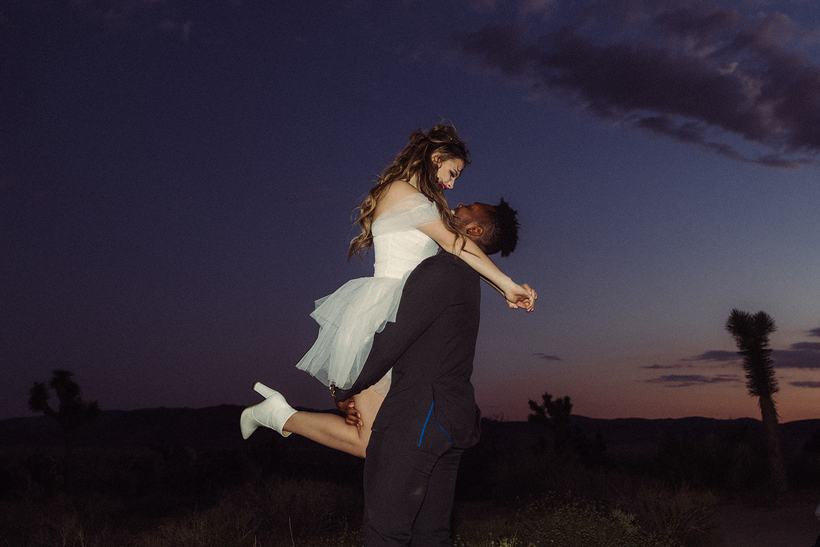 groom picking up the bride at sunset during a southern California elopement