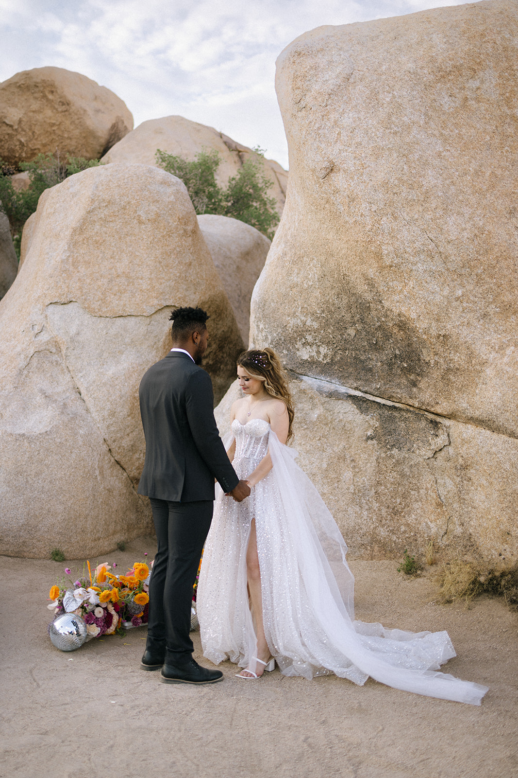 bride and groom standing at their floral installation during a southern California elopement