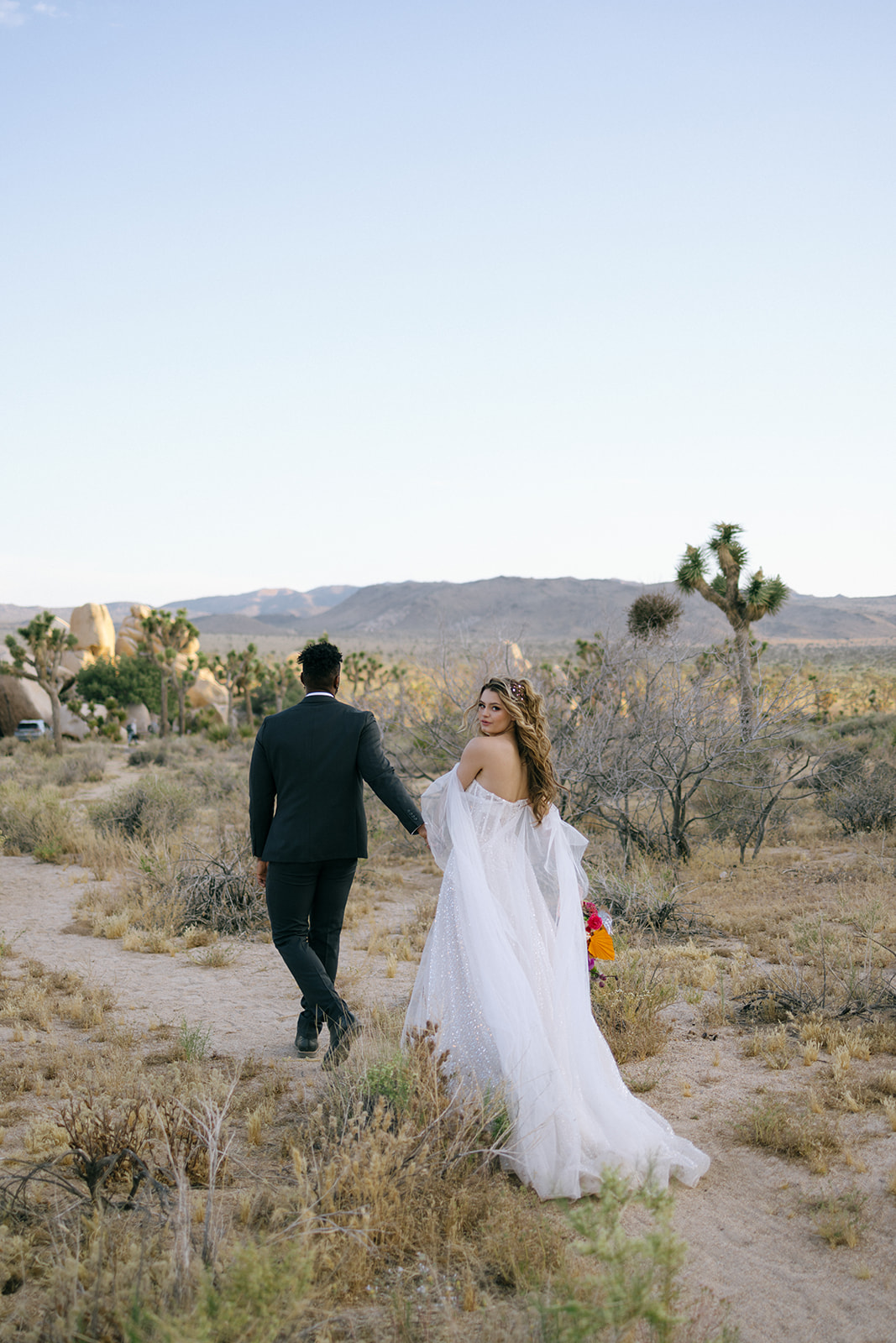 bride and groom walking through the desert during a southern California elopement