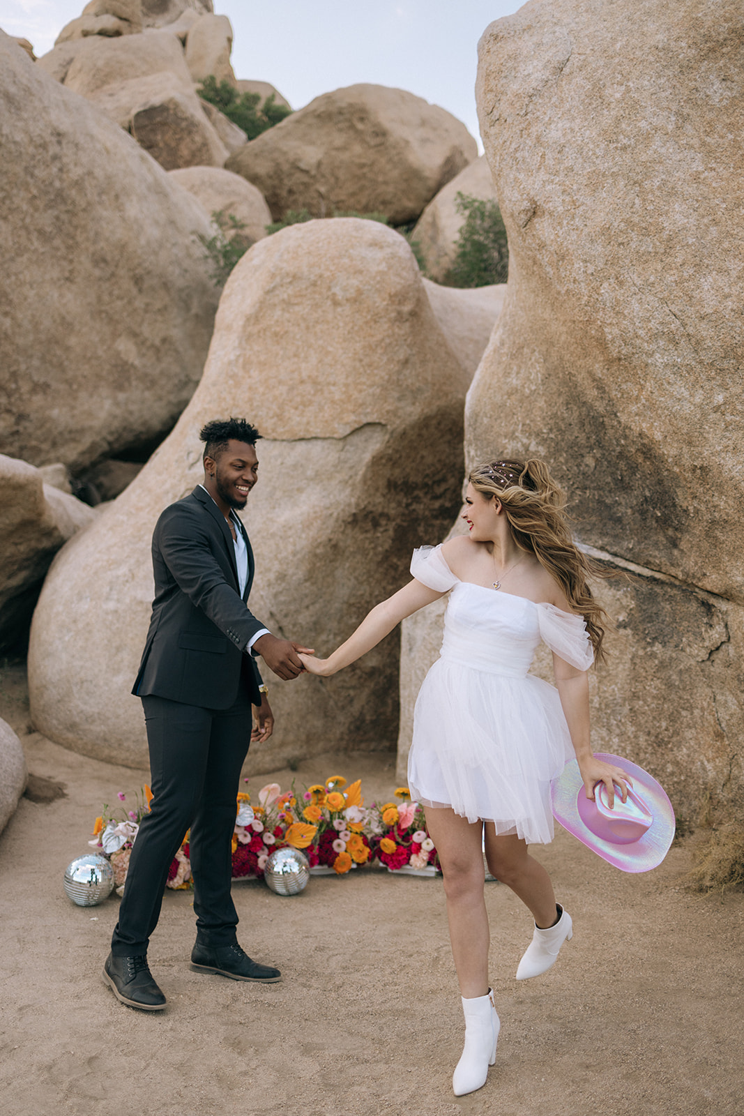 bride and groom dancing by their floral installation 