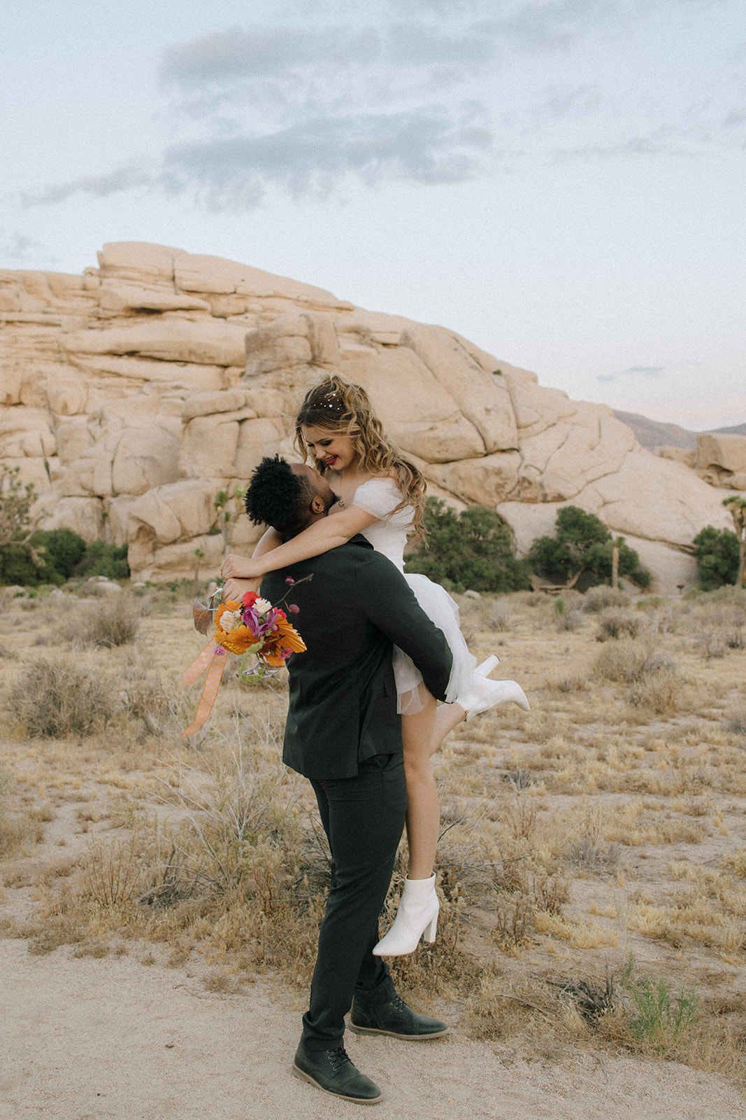 groom picking up the bride during a southern California elopement