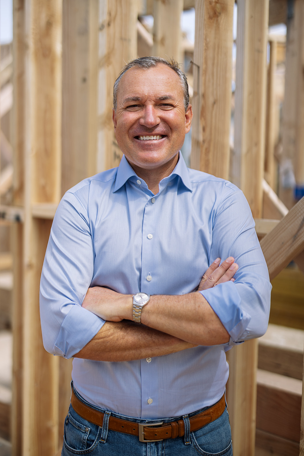 a man smiling at his job site in California during a brand photoshoot