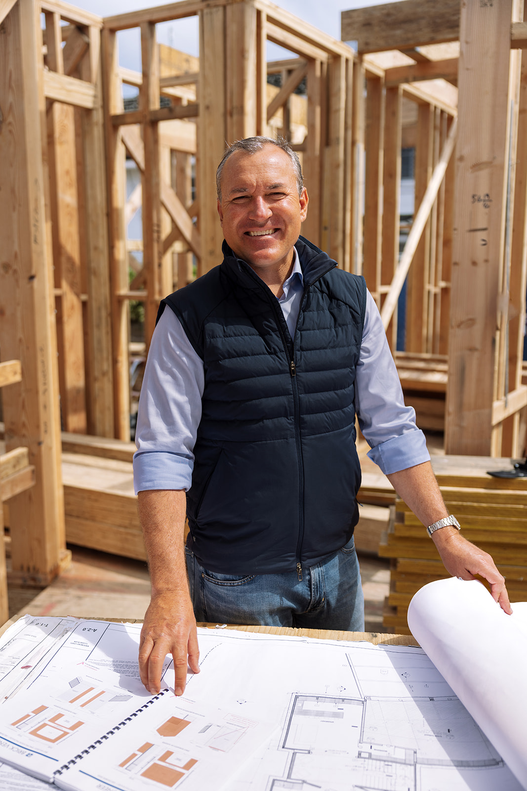 the owner of the company posing for a photo at a construction site in SoCal