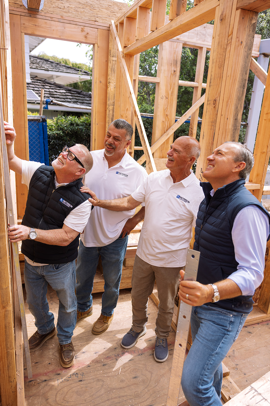 4 men working on framing a house during a brand photoshoot in Corona Del Mar