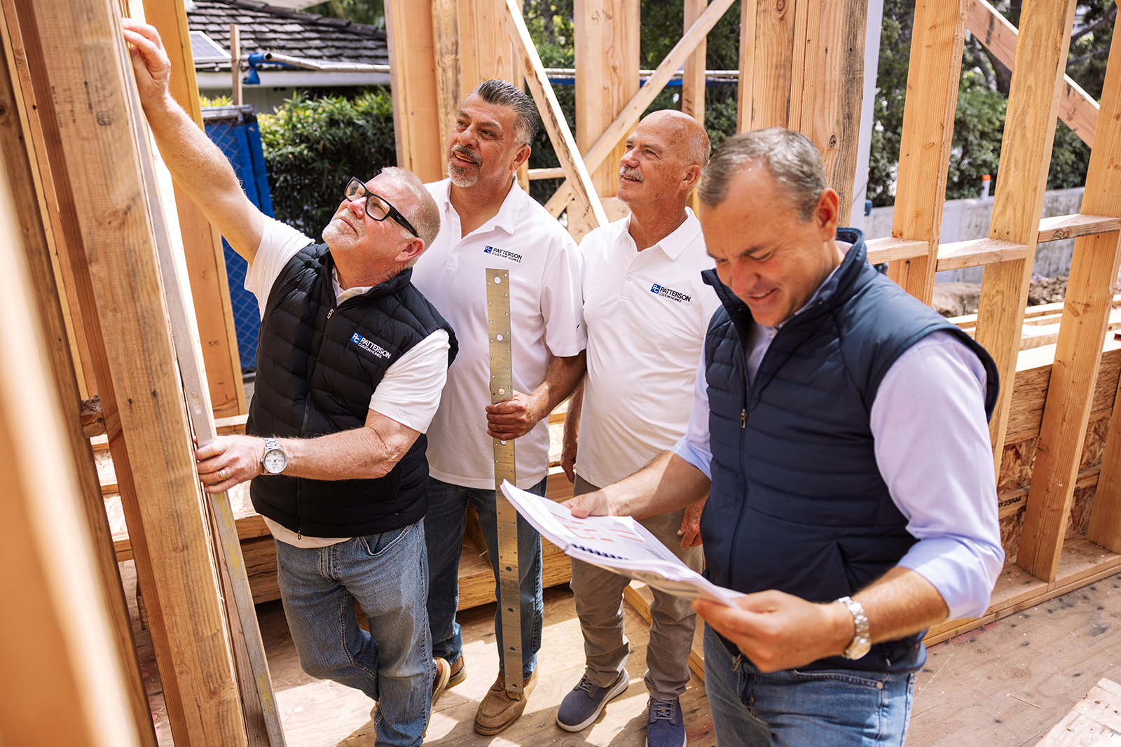 a group of men framing a house during a brand photoshoot
