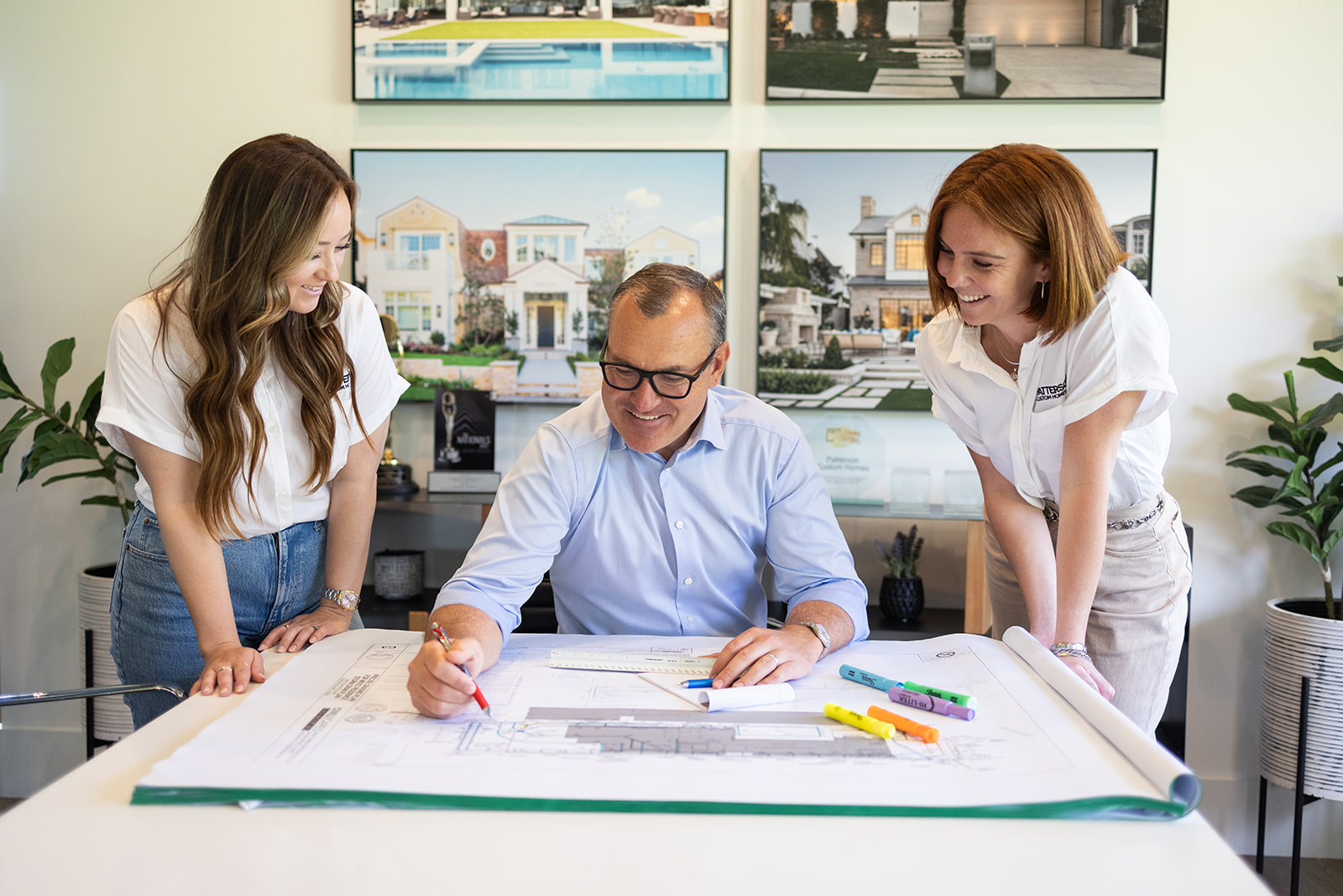 a man showing his cowers the design plans during an Orange County brand photoshoot