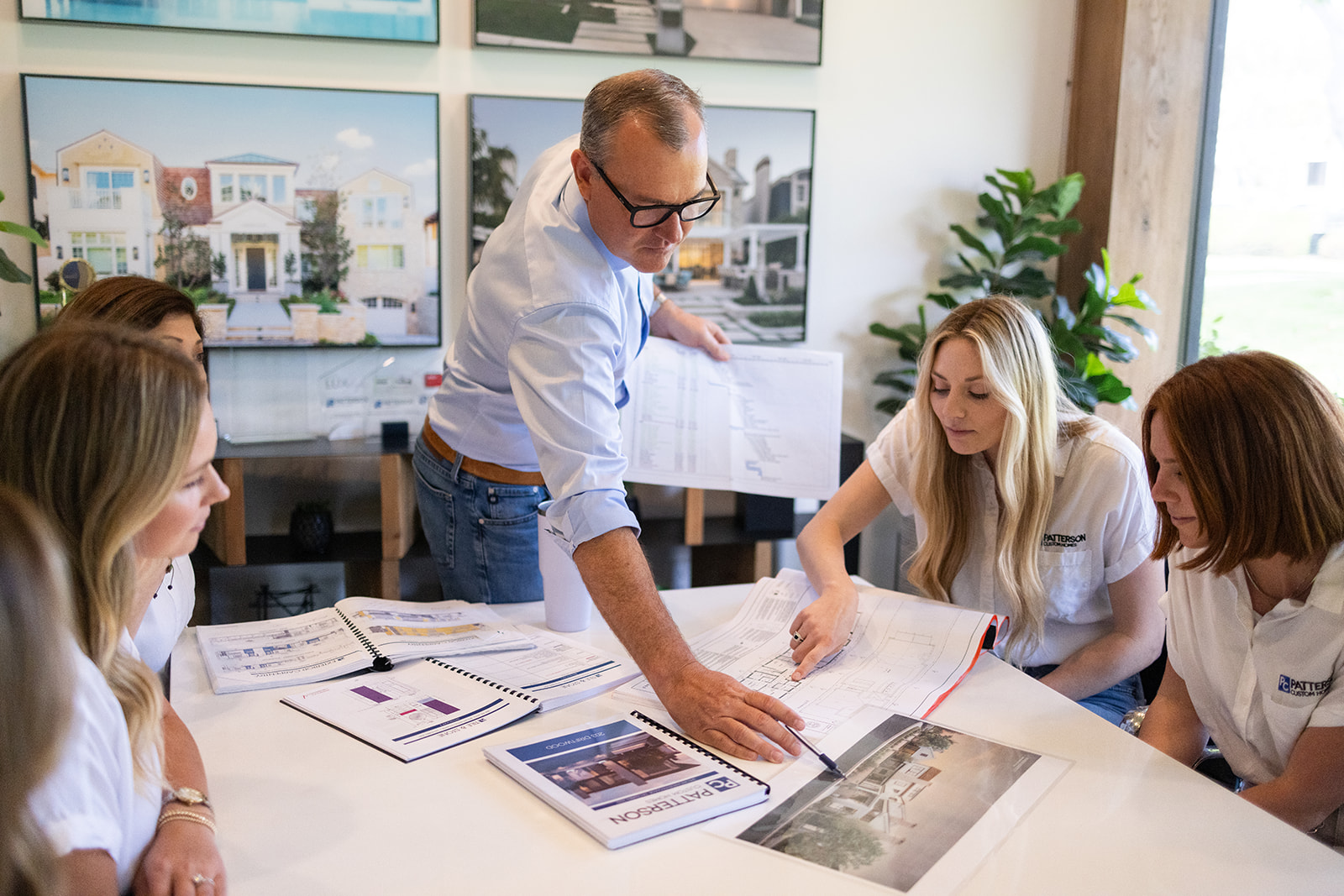 a man showing the table images during a brand photoshoot