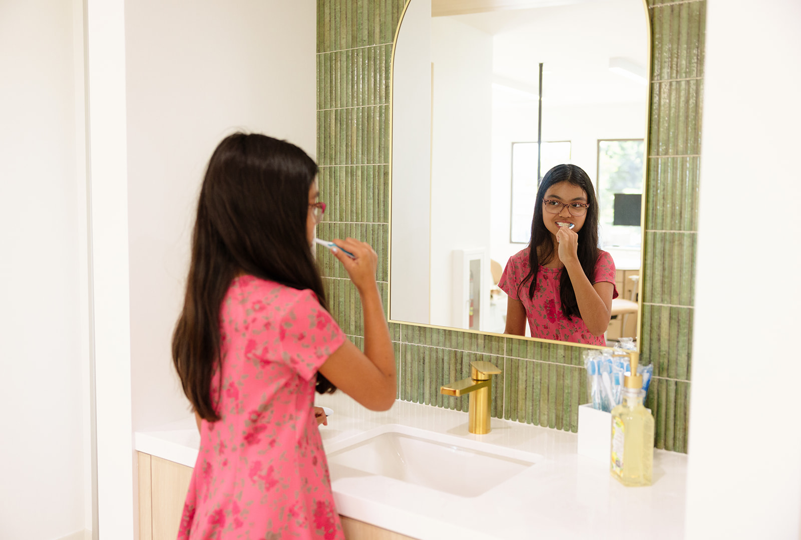 a girl brushing her teeth during a branding photoshoot in OC 