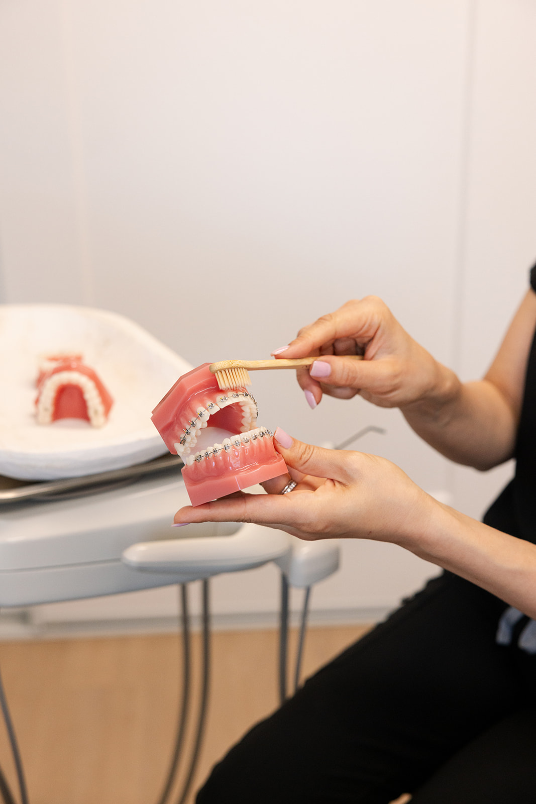 an orthodontist showing how to brush teeth with braces during a brand shoot in Southern California