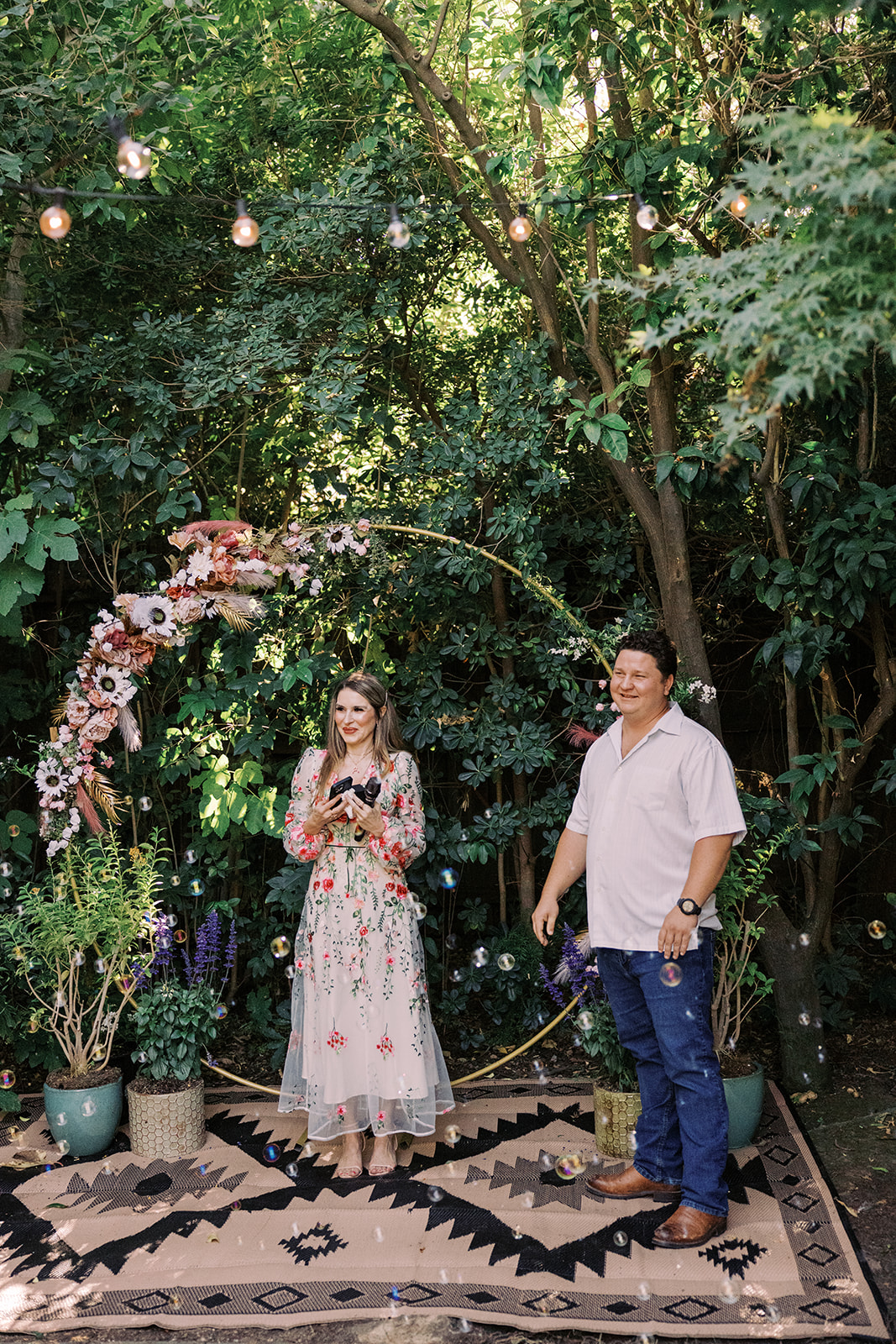 the groom smiling as he waits for the bride to reach the altar 
