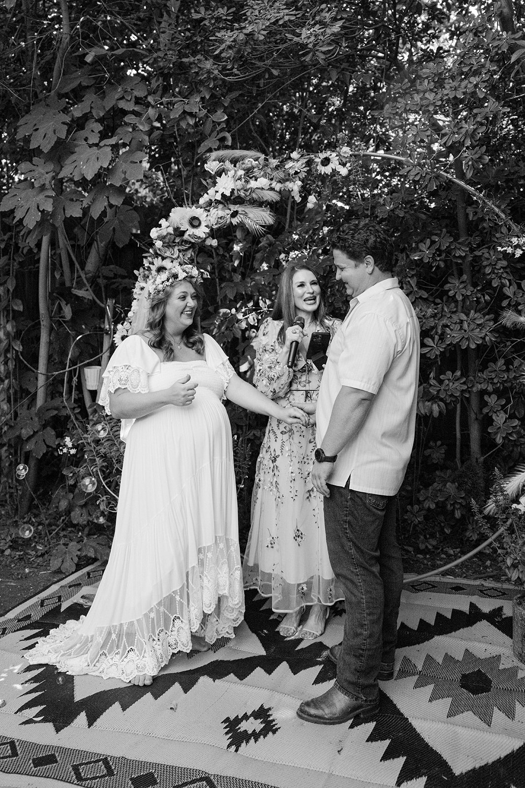 candid moment of the wedding couple standing at the altar for their Small Intimate backyard Wedding